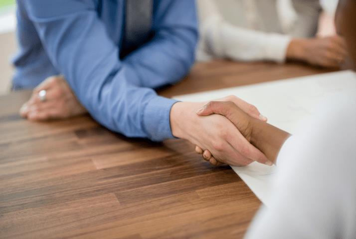 two hands after a merger and acquisition